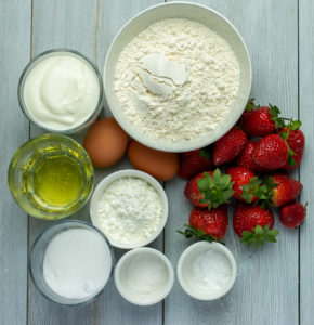 Fresh strawberry, dray and wet ingredients in room tempeture for strawberry muffins recipe